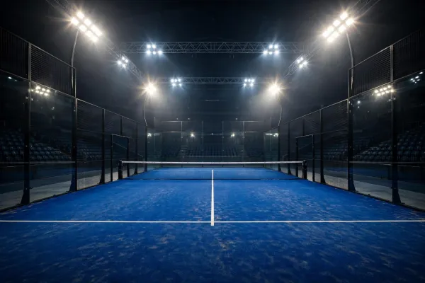 Floodlit padel arena at night